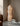 Interior image of a floor lamp made from webbing in a living space.