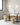 Modern dining area with glass tables, stools, and pendant lights.