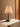 Table lamp with a textured shade on a neutral surface