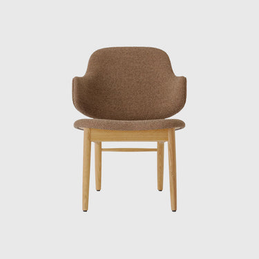 A mid-century modern armchair with a textured brown bouclé upholstered seat and curved backrest, supported by a light natural wood frame with tapered legs, shown against a solid light grey background.