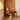Wooden chair against a wooden wall with soft lighting