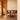 Dining area with wooden table and chairs in a well-lit room.