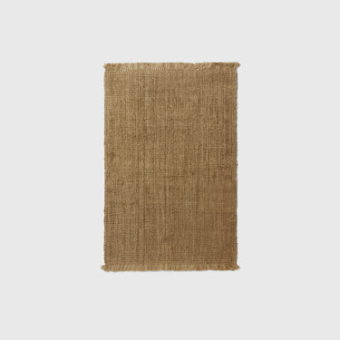 A rectangular, natural color jute rug with a textured weave and a soft fringe.