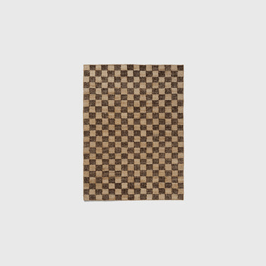 Checkered jute wool rug measuring 140 x 200 on a light grey background