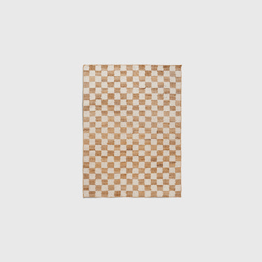 A checkered wool and jute rug in off-white and natural colours.