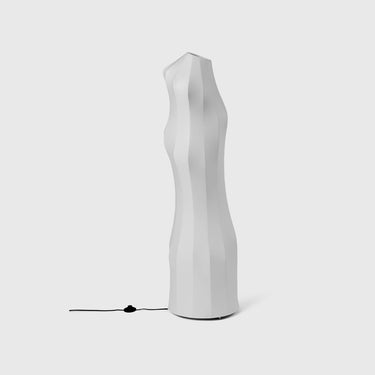 A white floor lamp with a unique, organic shape and a lampshade made of a powder-coated iron structure with a sprayed-on polymer skin.