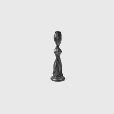 A black, recycled cast aluminum Gale Candle Holder with a swirling, organic shape.