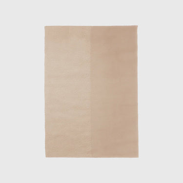 A rectangular beige rug with a dual-texture vertical seam, shown flat against a light gray background.
