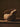 Brown textured chair on a wooden floor with a dark background