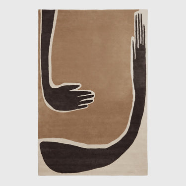An abstract area rug featuring a minimalist design of stylized arms and hands in dark brown, beige, and cream, shown flat against a light gray background.