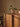 Wooden cabinet with decorative items against a beige wall