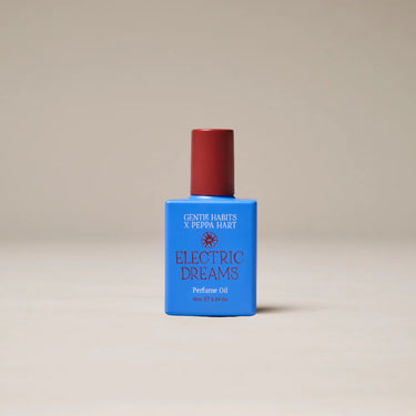 Perfume bottle labeled 'Electric Dreams' by Gentle Habits x Peppa Hart on a beige background