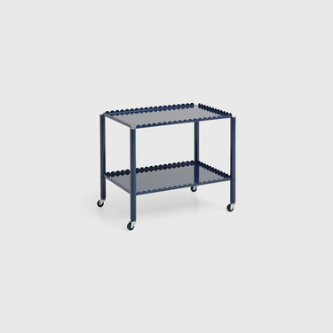 A blue Arcs Trolley Low with vertical arcs forming shelves, supported by slim legs on castors.