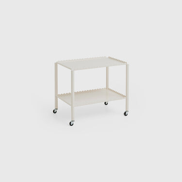 A white Arcs Trolley Low with vertical arcs forming shelves, supported by slim legs on castors.