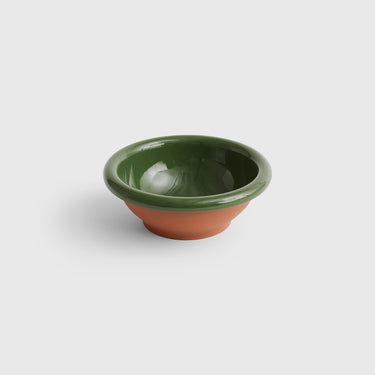 Green ceramic bowl on a white background