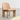 A contemporary upholstered lounge chair with a wooden frame and beige fabric seat, designed by Norwegian designer Andreas Bergsaker.