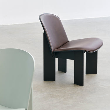 Lacquered Black beechChisel Lounge Chair with Sense leather upholstery in dark brown.