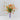 Bouquet of orange flowers in a lavender vase on a light grey interior background