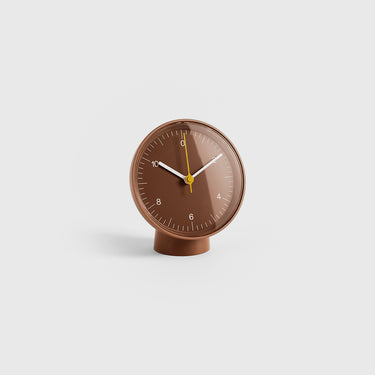 Brown table clock on a light gray background