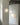 Three spherical pendant lights hanging in a minimalistic room with concrete ceiling.
