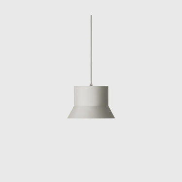 A minimalist pendant light with a wide, flared white shade and a thin vertical hanging rod, shown against a solid light gray background.