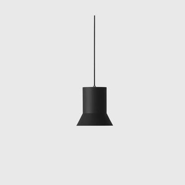 A minimalist black pendant light with a tapered cylindrical shade and a thin hanging rod, centered against a solid light gray background.