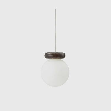 A modern pendant light with a frosted white glass globe shade and a dark brown textured ring accent, suspended by a thin white cord against a light gray background.