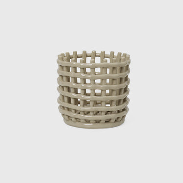 A small beige ceramic basket with an uneven texture, resembling traditional woven container.