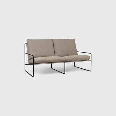 A 2-seater outdoor sofa with a black steel frame and dark sand colored cushions.