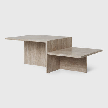 A travertine coffee table with a minimalist design featuring a flat top and angled lower shelf, primarily in a natural beige color.