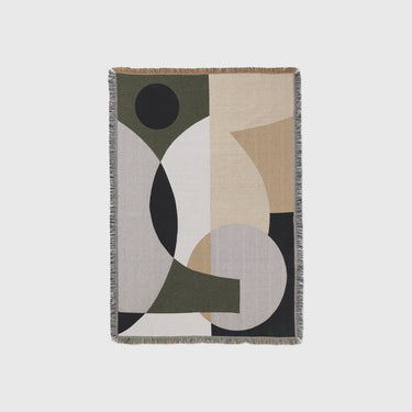 Geometric Tapestry blanket with earth tone colours on a light grey background.