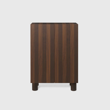 A smoked oak brown post storage cabinet with striped wood detailing and two shelves, set against a plain background.