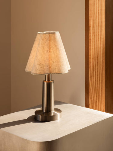 Table lamp with a textured shade on a neutral surface