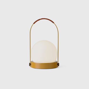 Golden yellow portable lamp in a light grey background.