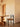 Wooden chair and table in a minimalistic room with neutral walls.