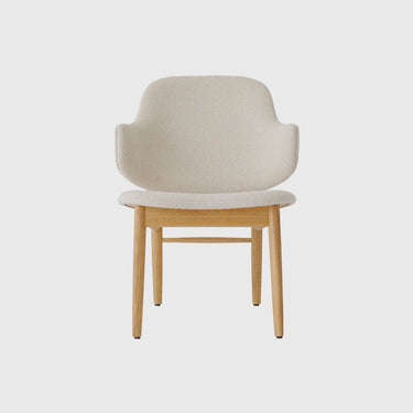A modern dining chair with a light beige textured bouclé upholstered seat and curved backrest, supported by a natural light wood frame with four tapered legs.
