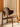 Wooden chair with a curved backrest and seat in a minimalistic setting.