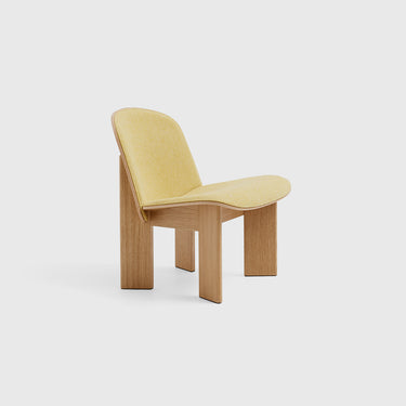 A contemporary Chisel Lounge Chair with a beige upholstered seat and a dark wooden frame.