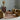 Interior image with a rug, sofa, two lounge chairs and a coffee table in a well lit room.