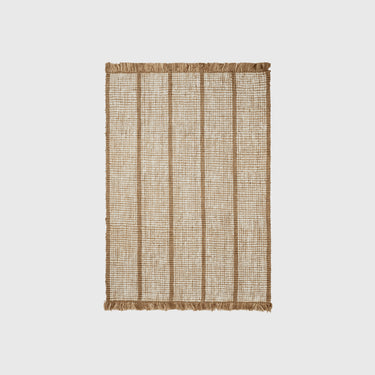 A rectangular natural jute rug with vertical woven stripes and fringed edges, shown flat against a light gray background.