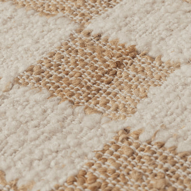Up close detail of a woven jute checkered rug. 