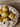 White ceramic bowl filled with pears on a beige background