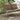 Exterior image of a two seater outdoor sofa in cashmere and dark sand