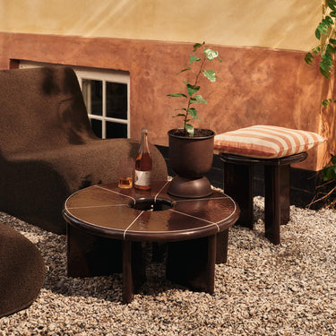 Outdoor patio setting with furniture and a bottle on a table.