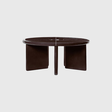 Round brown coffee table with a glossy finish on a light gray background