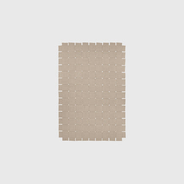 Rectangular woven mat with a grid pattern on a light gray background