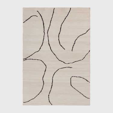 A handwoven beige and dark brown jute rug with an abstract pattern.