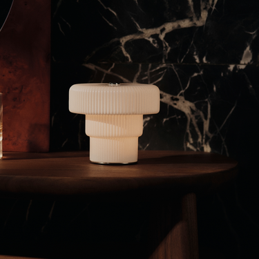 portable table light on wooden table and marble background