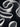 Abstract close-up of sculptural rolled and curved white forms against a dark black background.