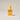 Yellow bottle of Gentle Habits Noosa perfume oil on a beige background